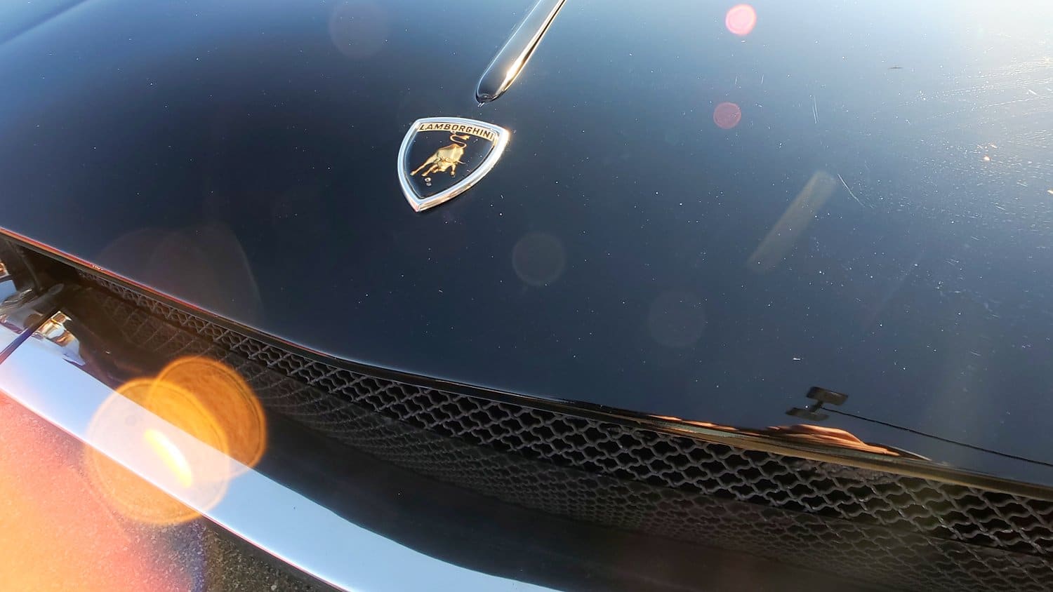 Hood and chrome bumper of Lamborghini.