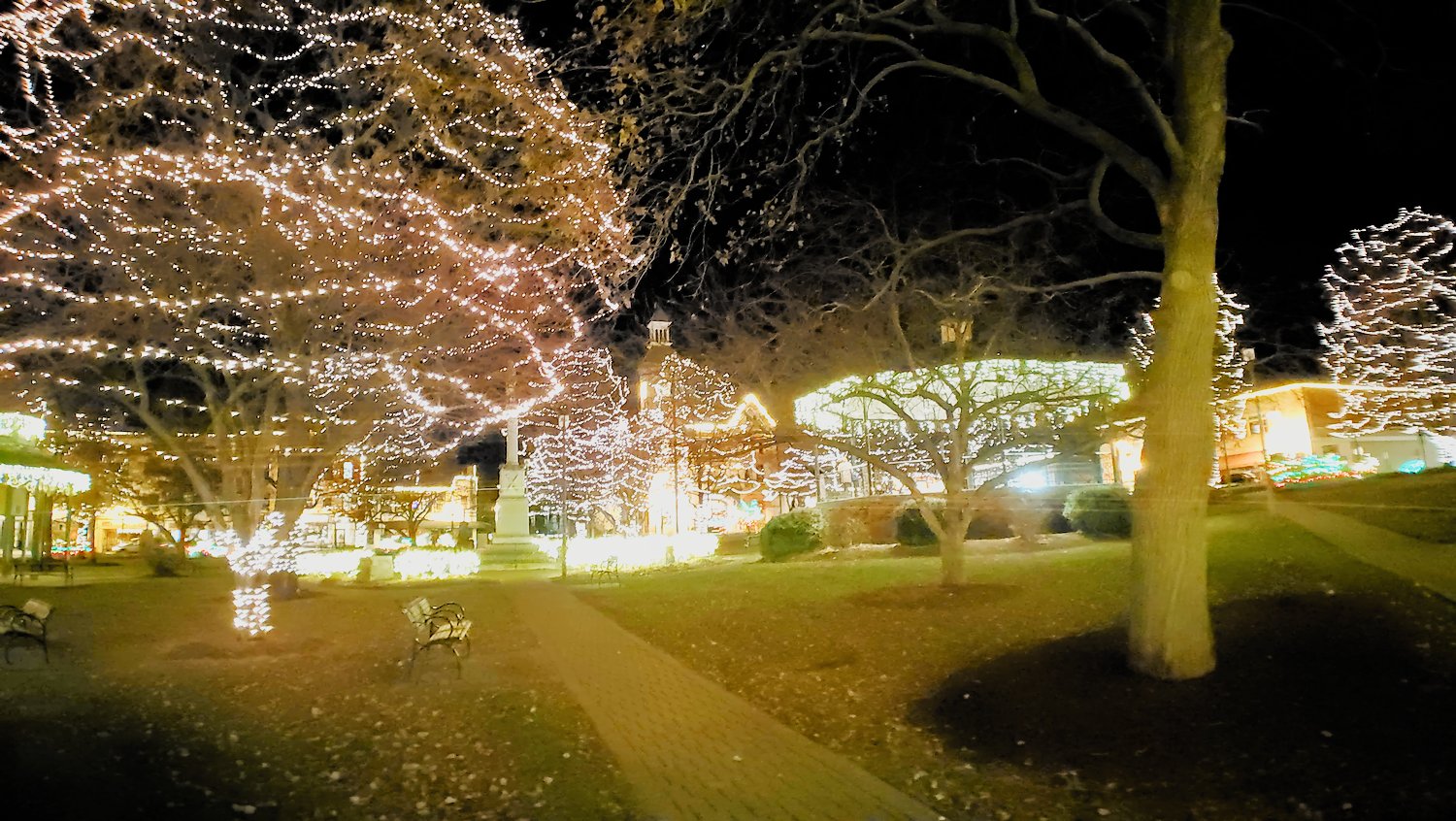 Lights on the trees, bushes, and band stand at the Historic Square in Woodstock, IL.