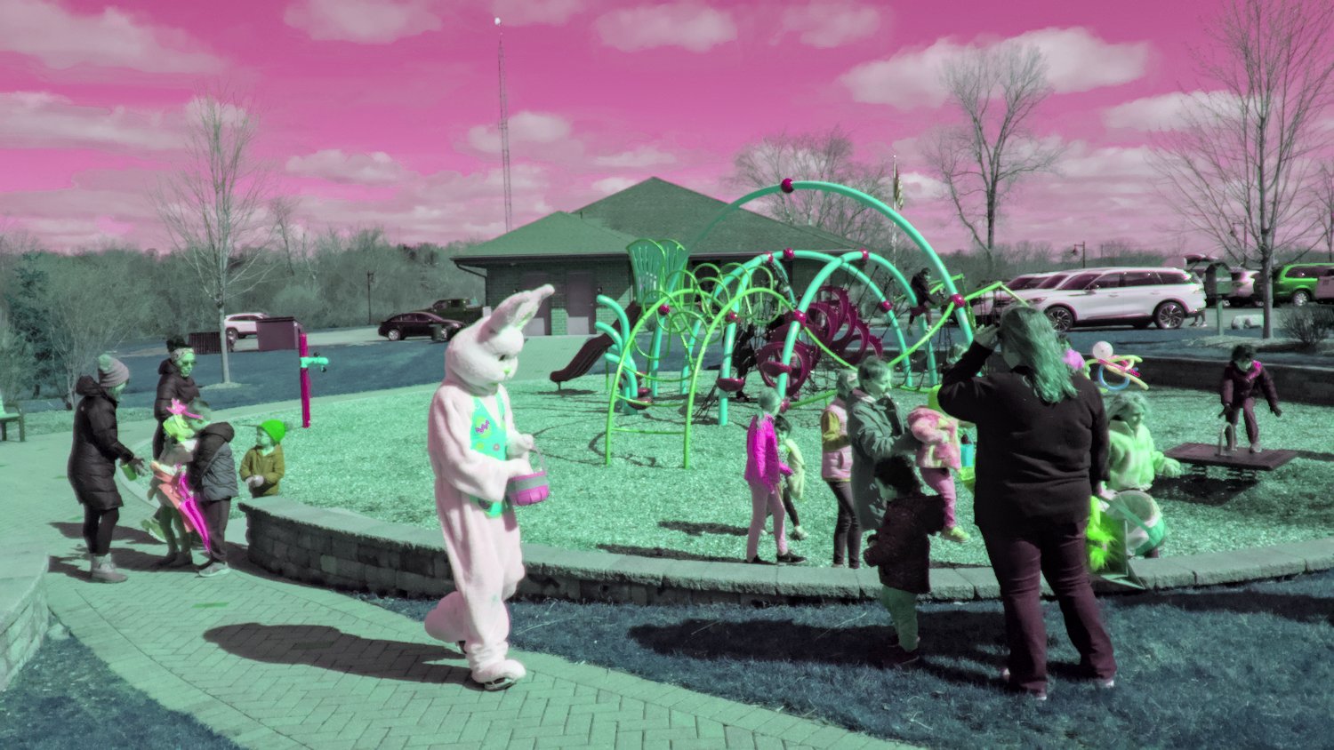 Easter Bunny with kids at playground.