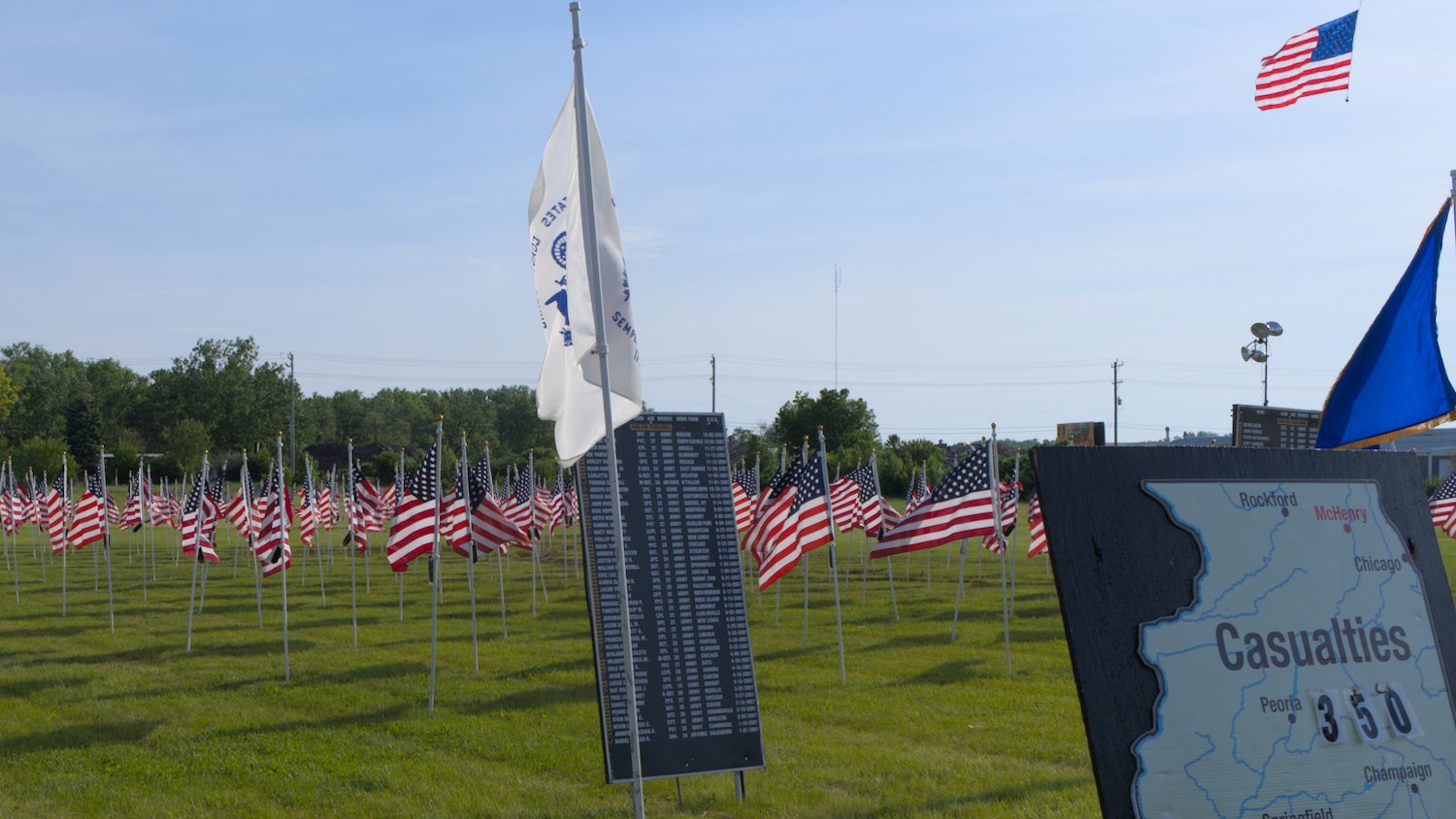 U.S. flags, fallen service member name boards, and location board for Illinois.