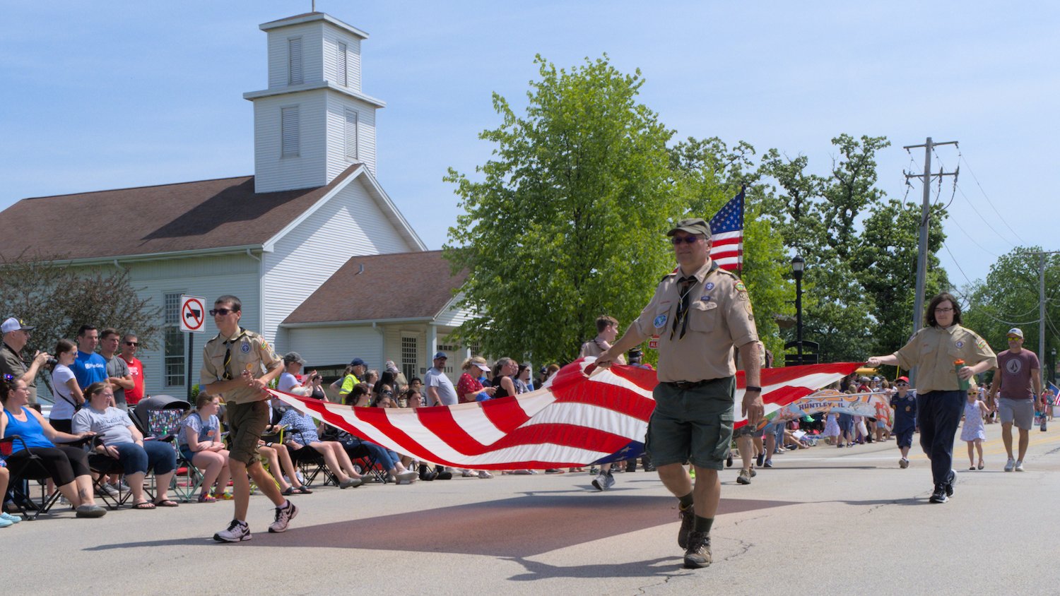 Scouts carrying large U.S. flag.