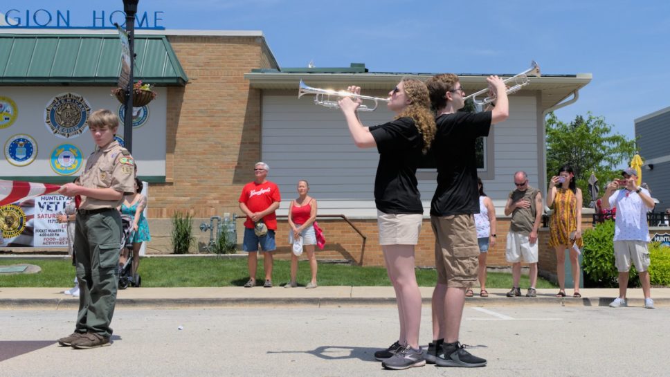 Two Huntley marching band trumpeters playing Taps.