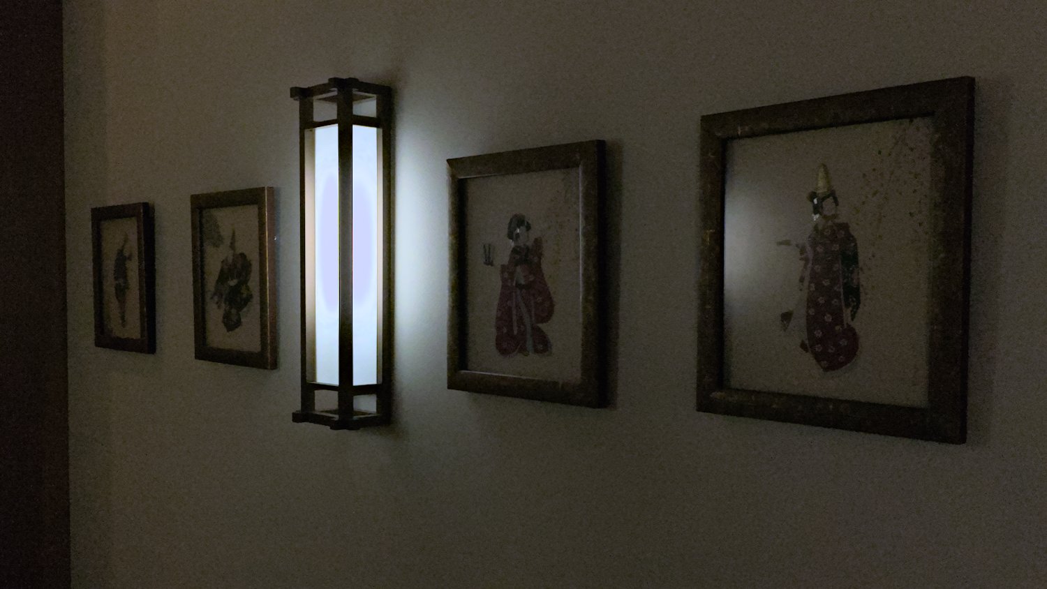 Wall sconce and Japanese wall art.