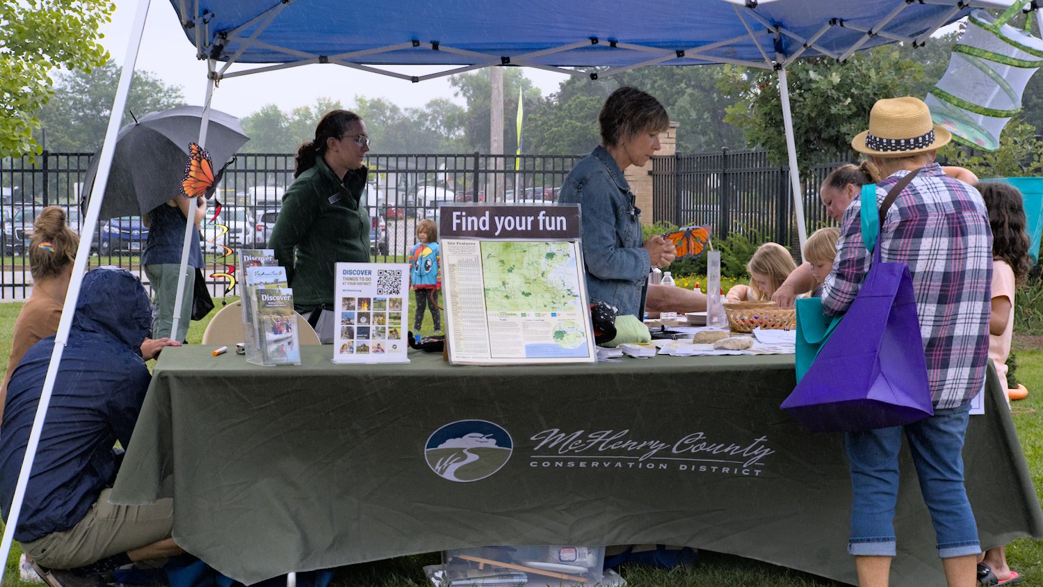McHenry County Conservation District tent with coloring pages and information about county conservation sites.