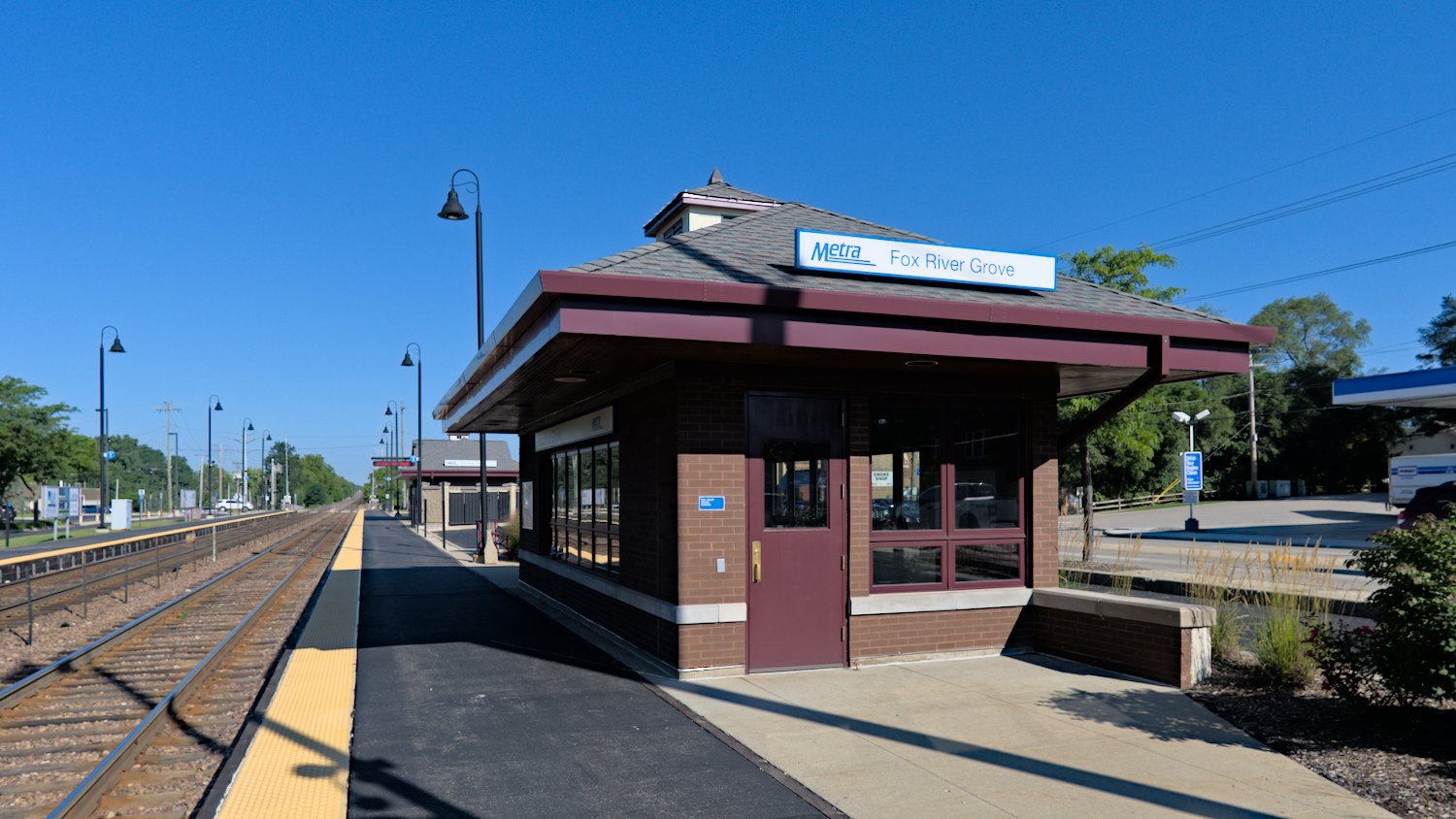 Fox River Grove Metra waiting shelter with main station in background.