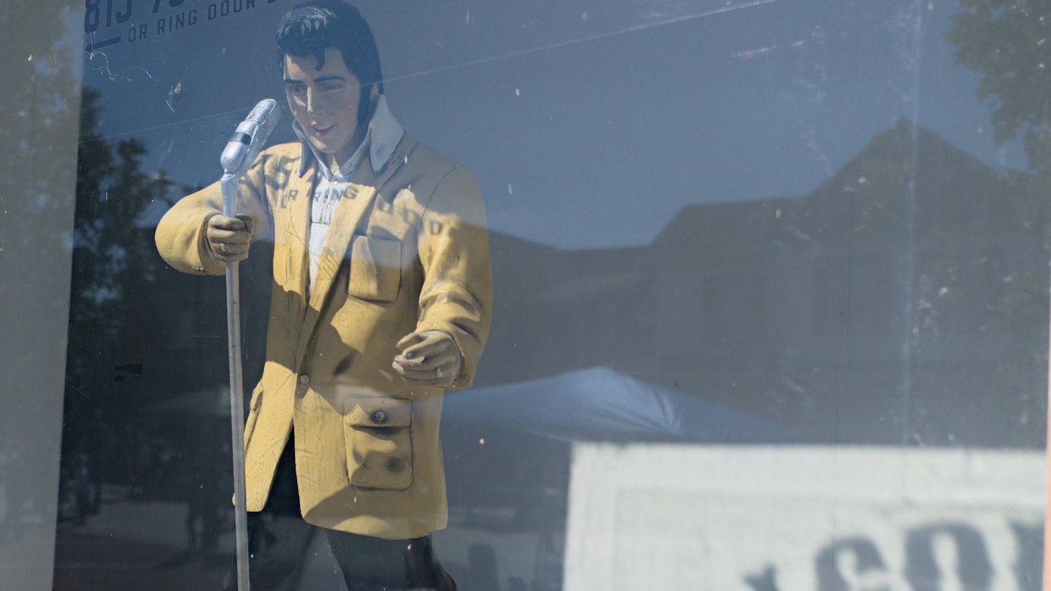 Elvis Presley figurine in a shop window.