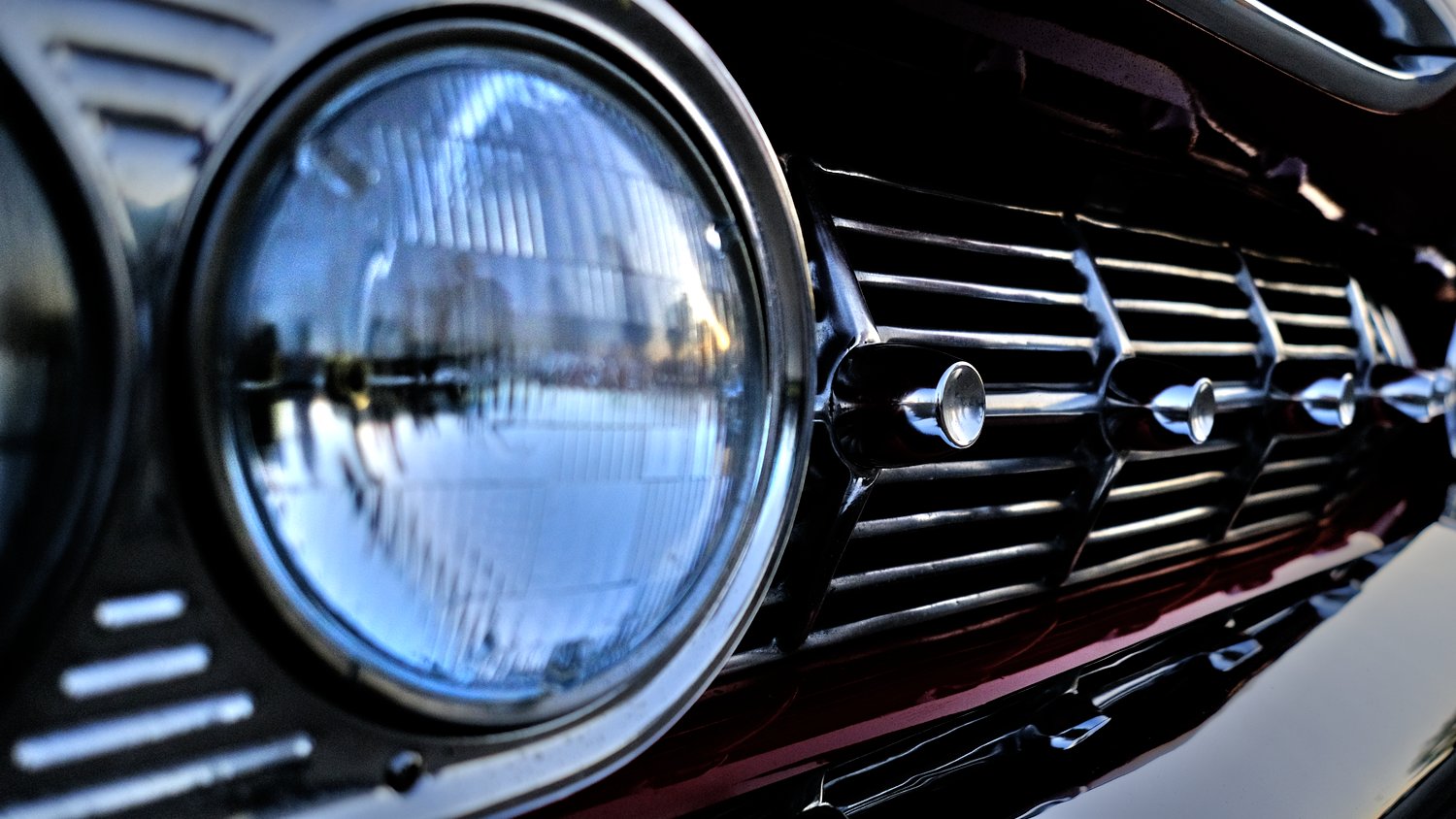 Headlight and chrome grille detail on Chevrolet Impala.