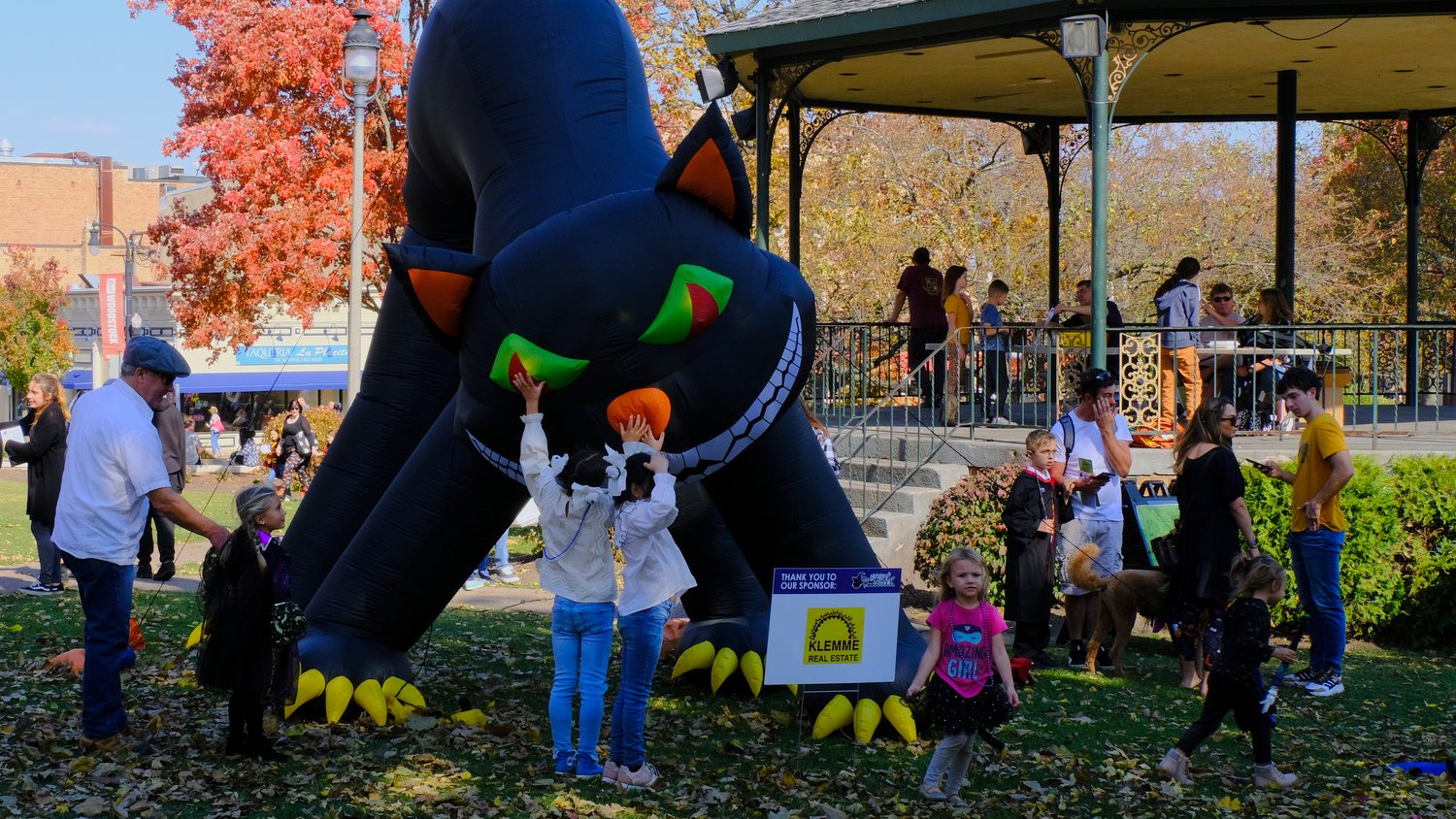 Kids playing with giant inflatable black cat.