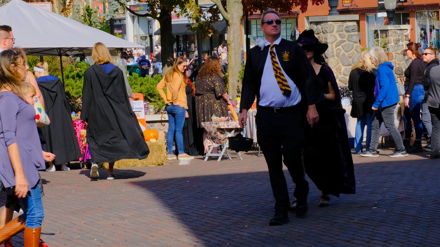 Cosplayers walking the cobblestone streets around the Historic Woodstock Square.