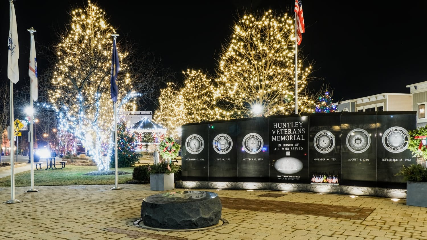 Huntley Veterans Memorial surrounded by Christmas lighting.