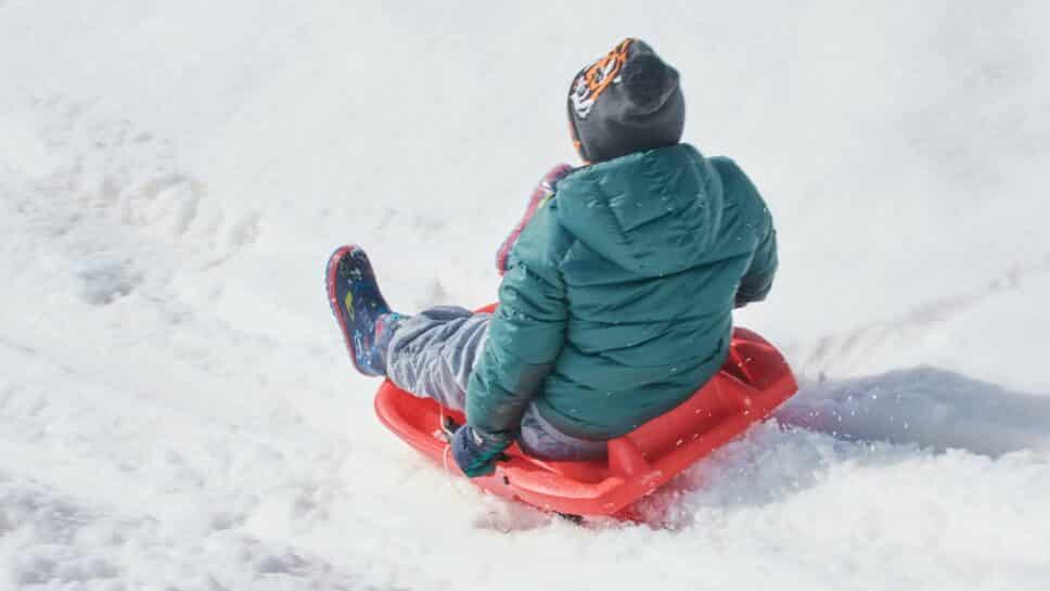Boy sledding in the winter.