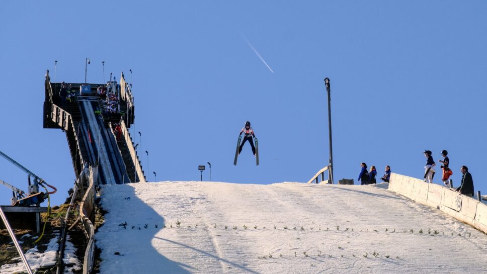 Ski jumper in the air over the knoll at the 118th Annual Norge Ski Club Winter Tournament.