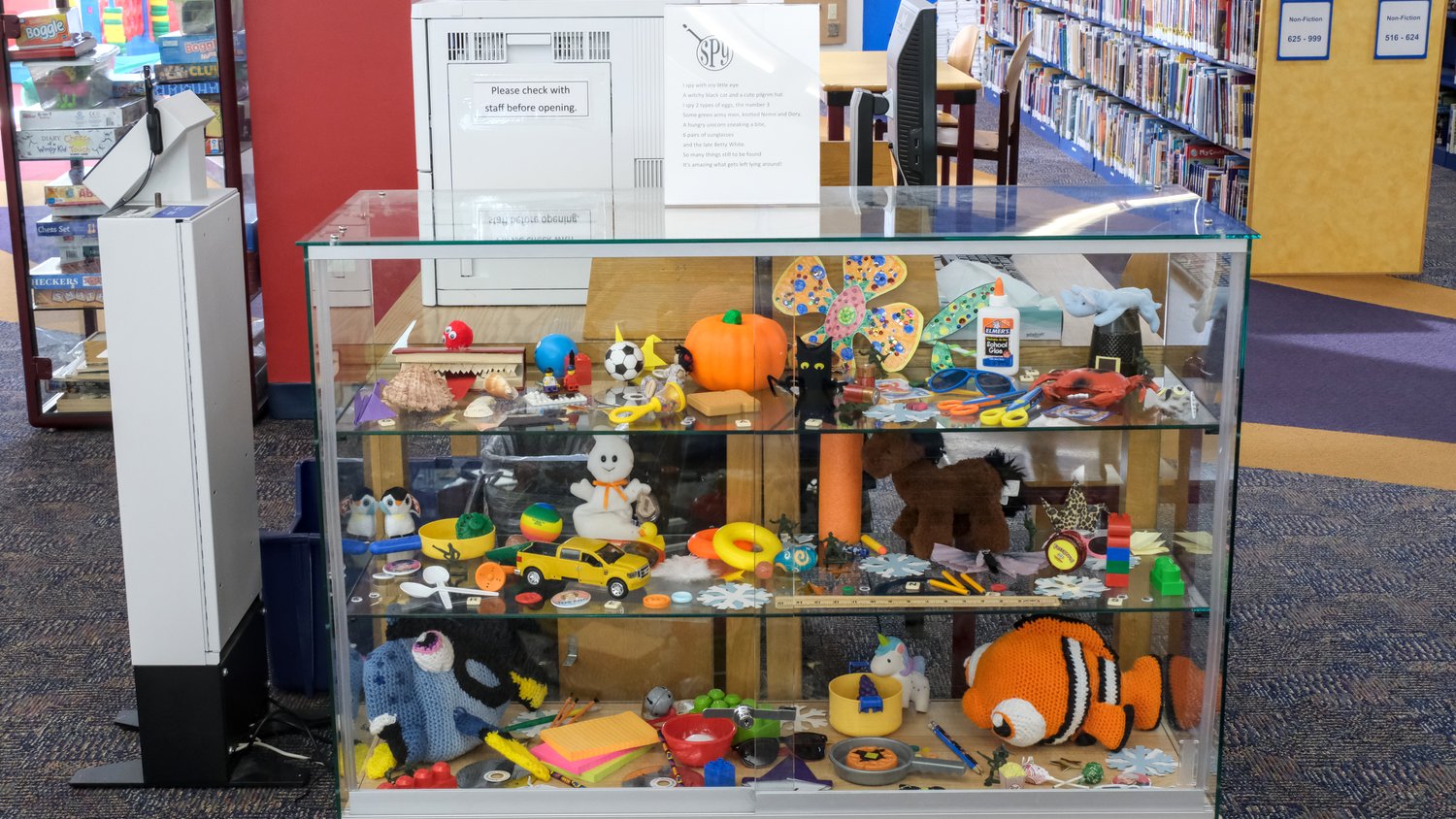 Glass display cabinet used as a large I Spy game.