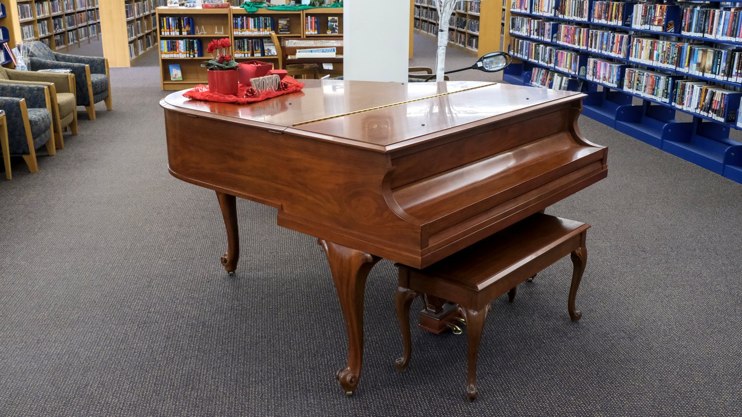 Baby grand piano near the entrance of the Woodstock Public Library.