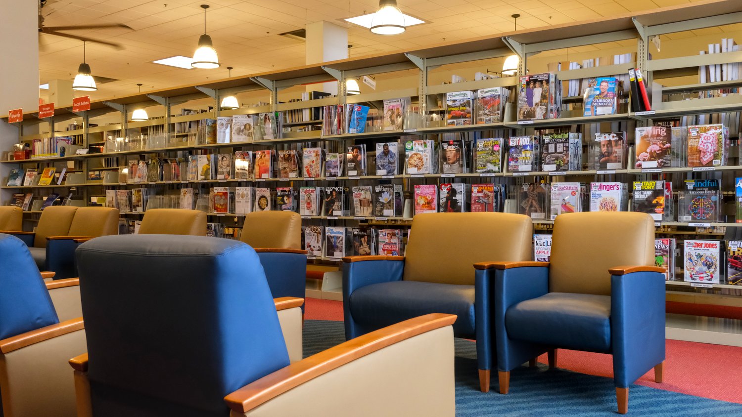 Rows of chairs line the magazine and periodicals area.