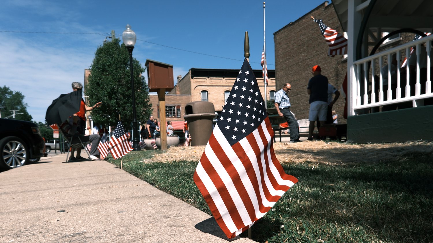 Flags lining the sidewalk at Stevens Park in Richmond, Illinois for the Memorial Day service.