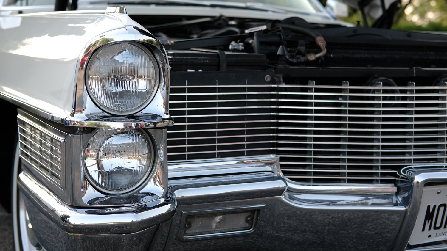 Front corner view of headlights and grille.