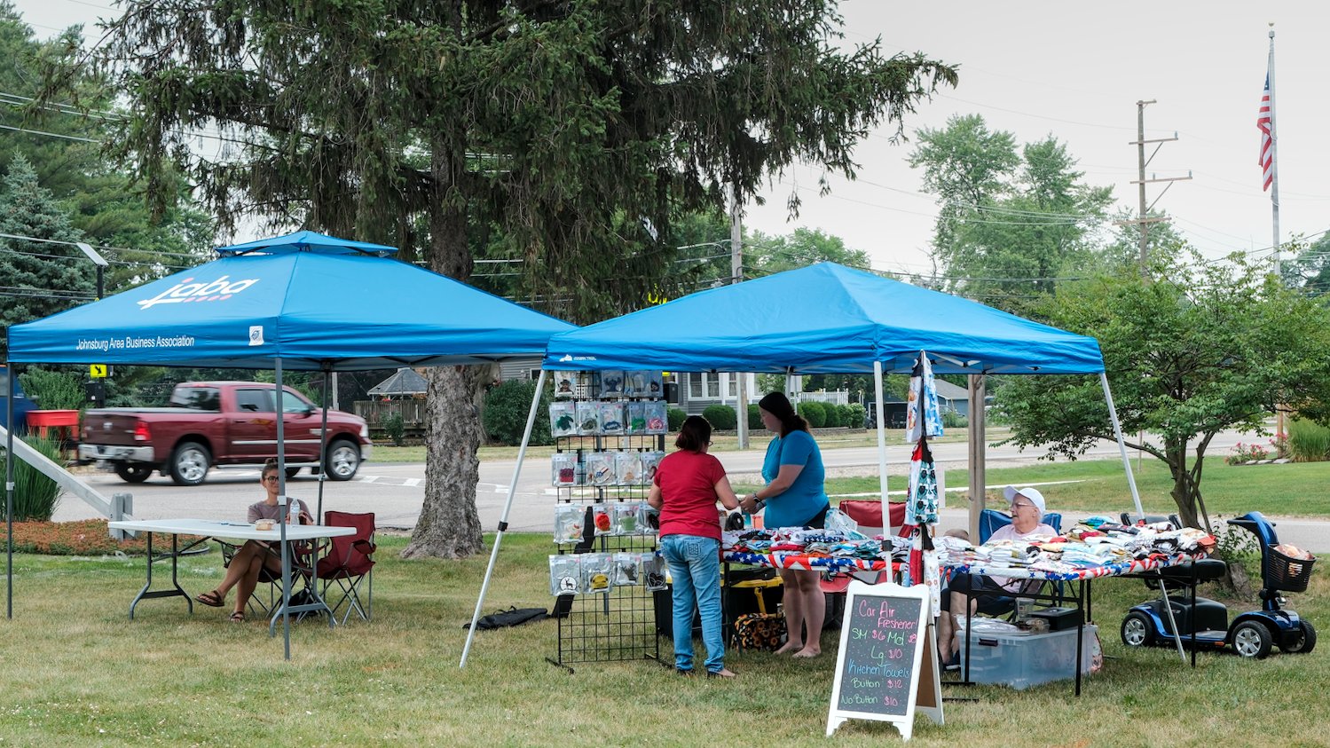 Johnsburg Area Business Association tent and a vendor selling various home items.