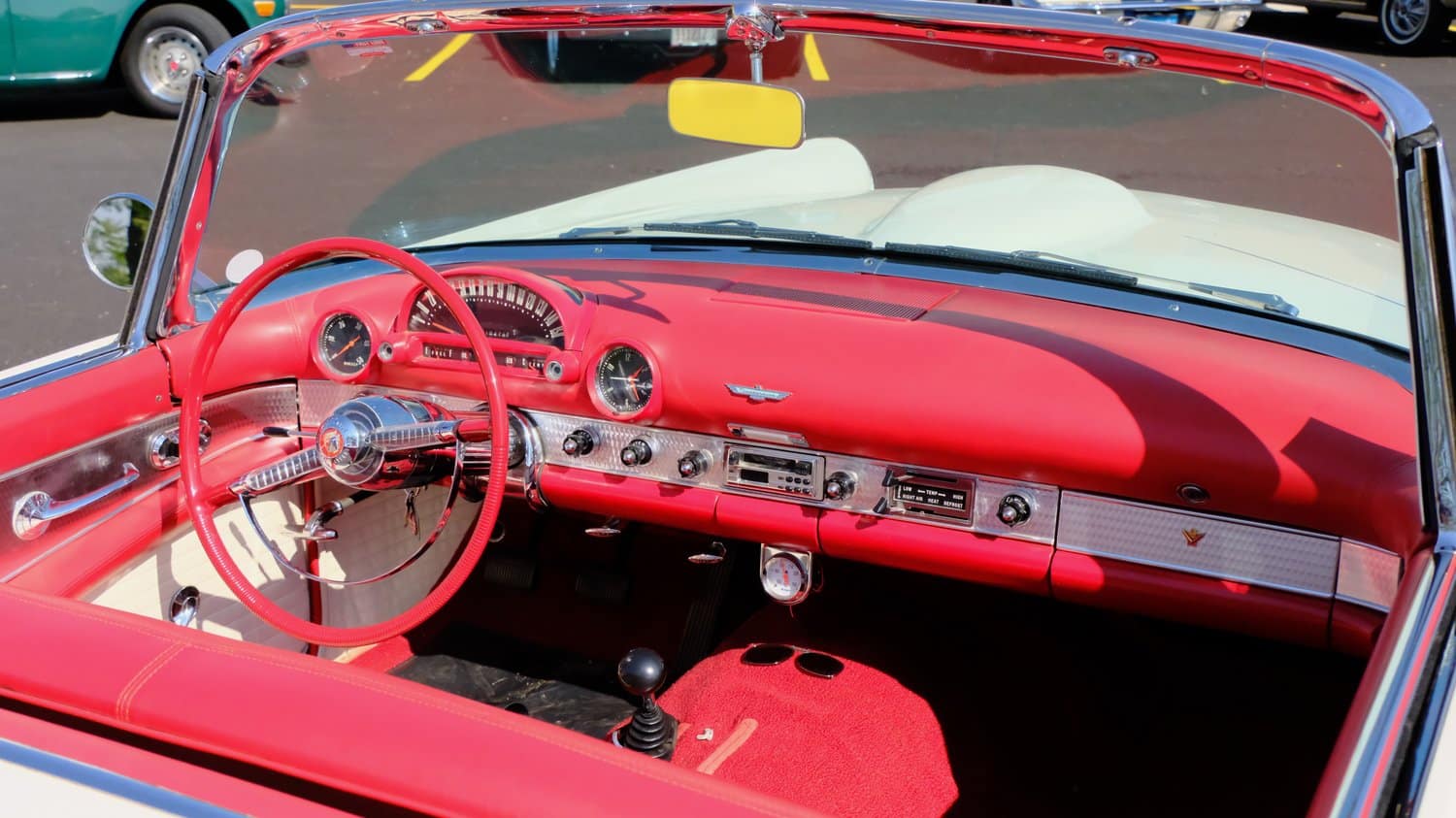 Red, white, silver, and black interior of a white Ford Thunderbird.