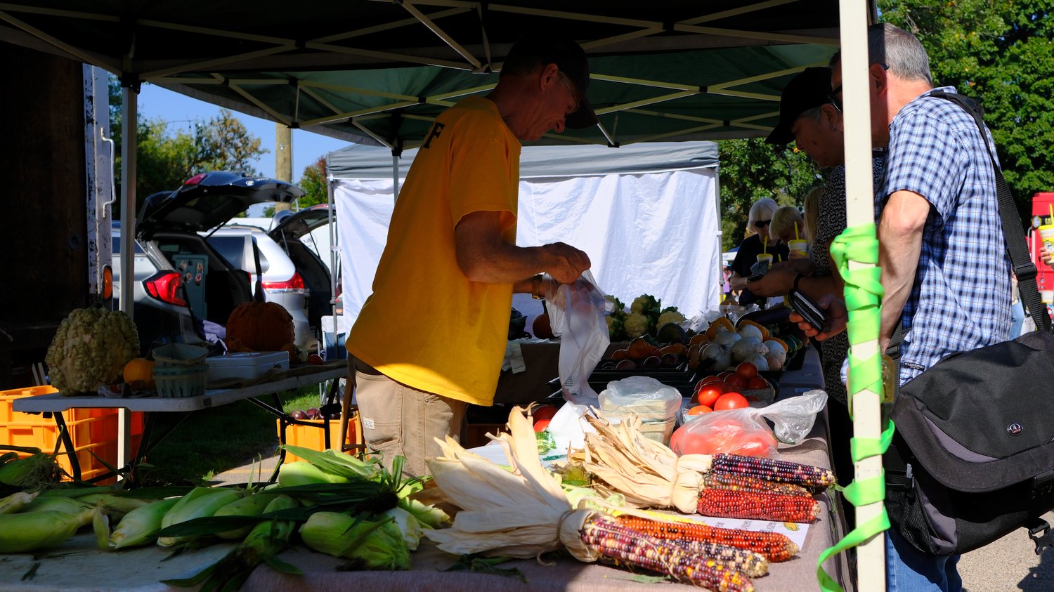 Bagging produce at the farmers market.