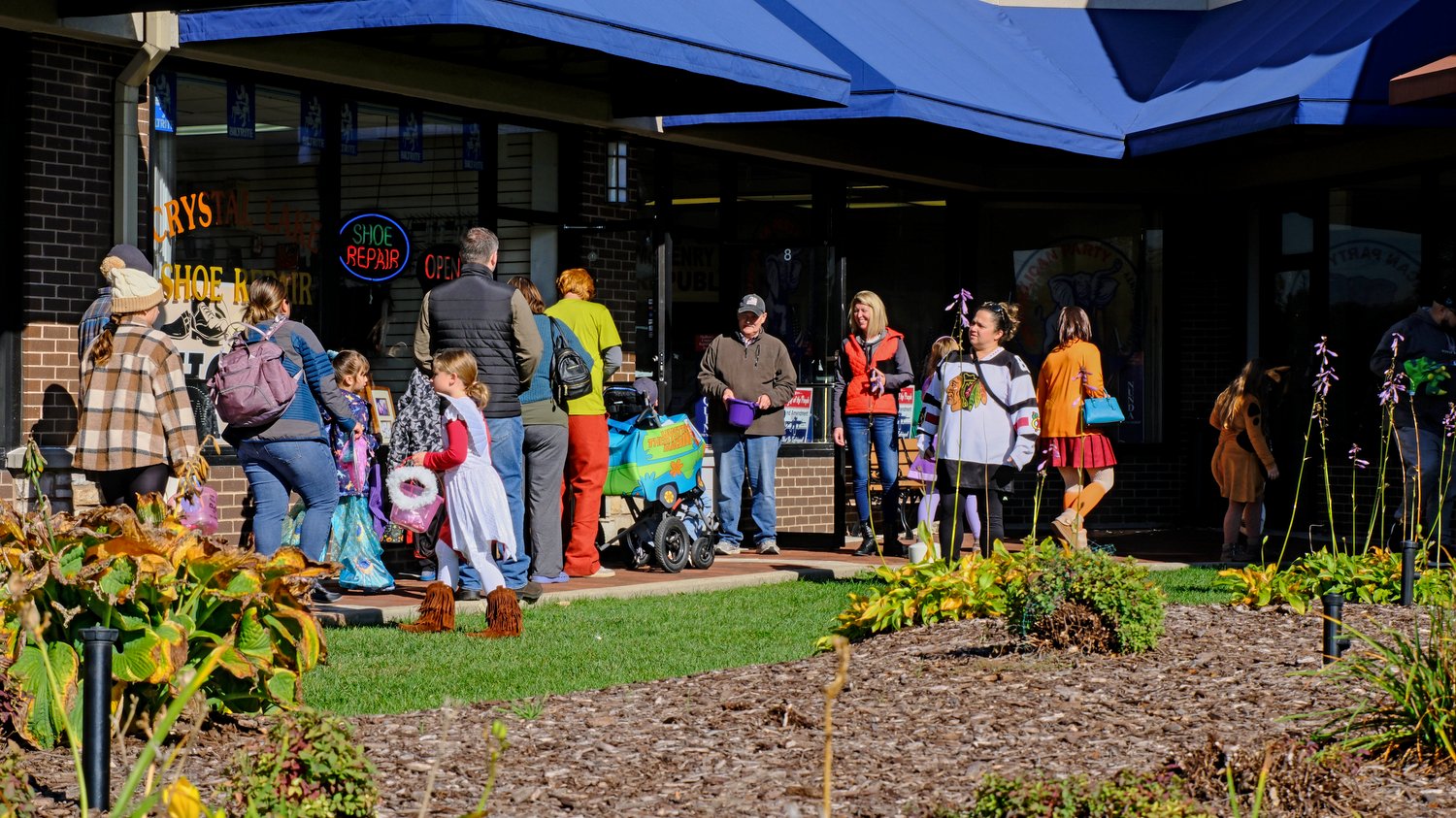 Trick-or-treating outside of the stores.