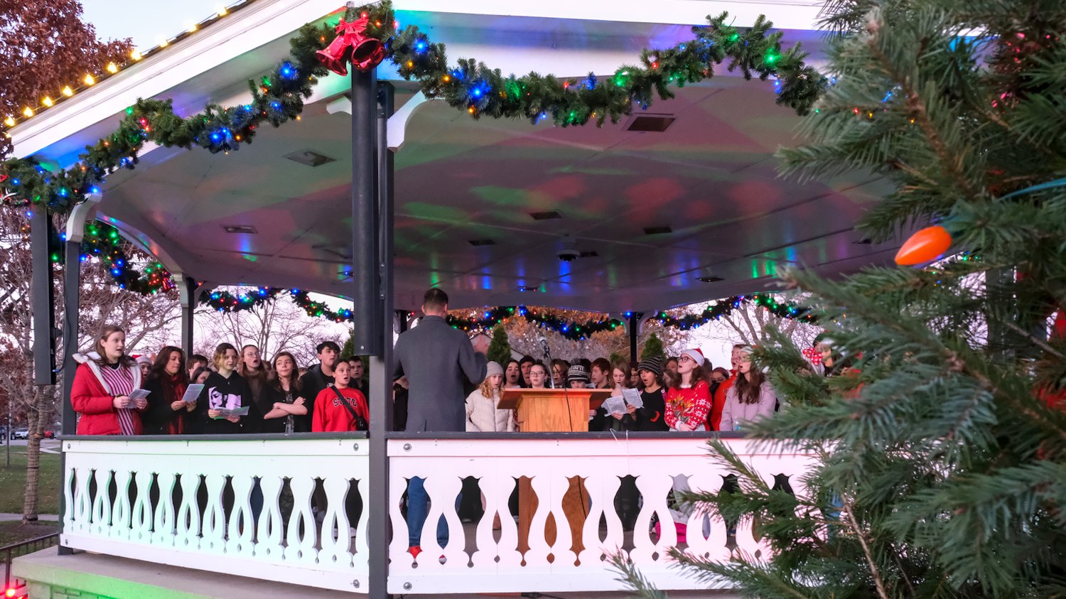 Choirs in the gazebo singing Christmas carols.