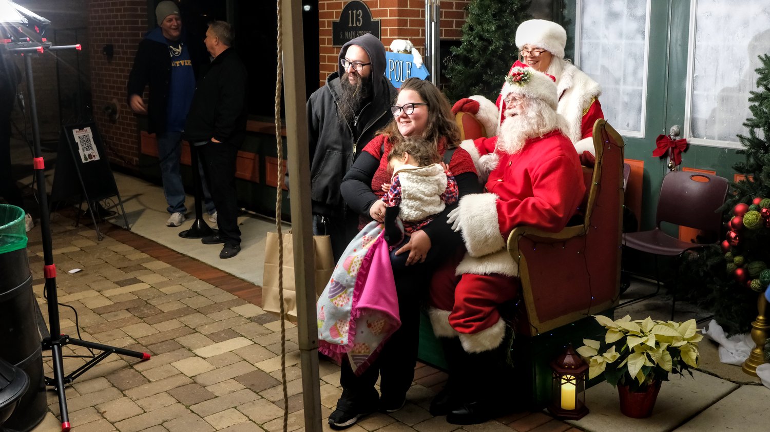 Family getting their photo taken with Santa and Mrs. Claus.