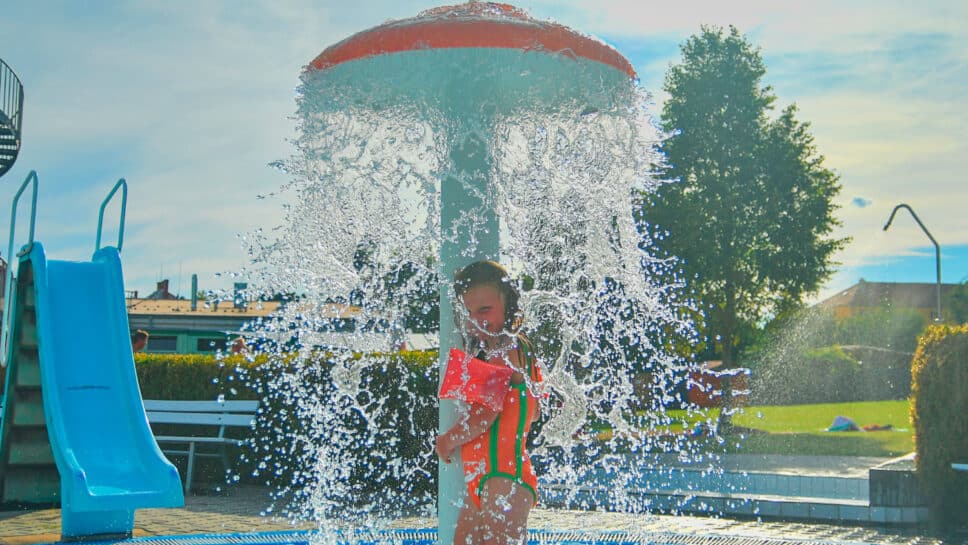 Little girl playing in splash park.