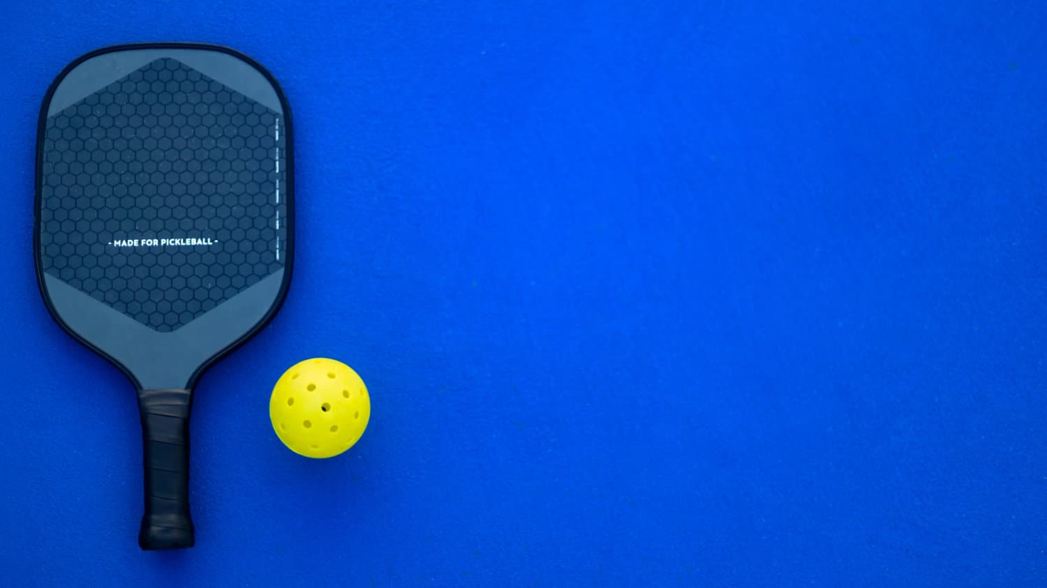 Pickleball paddle and ball.
