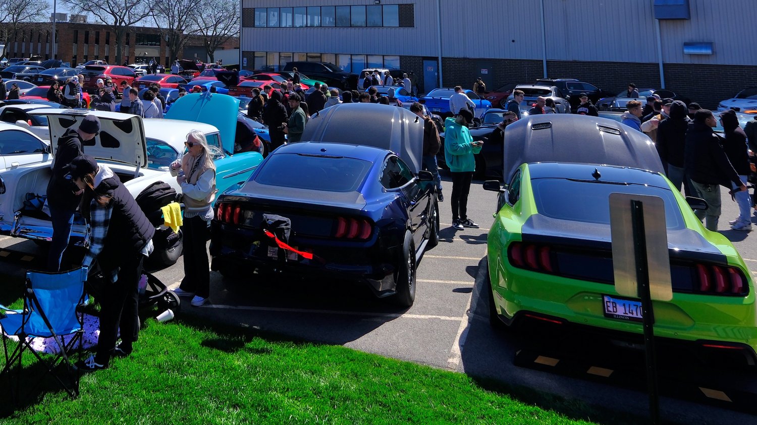 Cars and people at the Cars and Coffee car show at Illinois Motors.