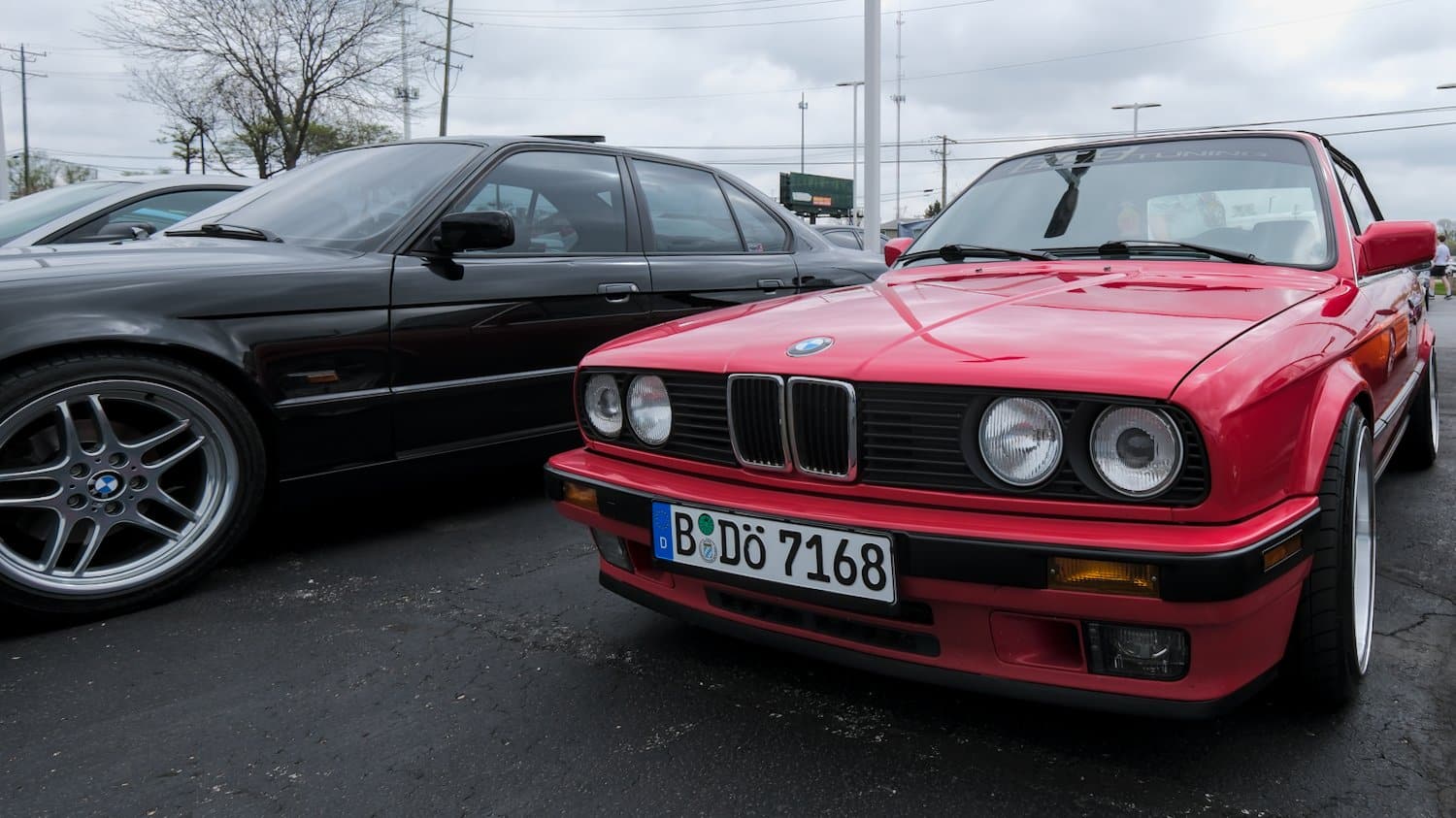Classic red BMW 3-series convertible.