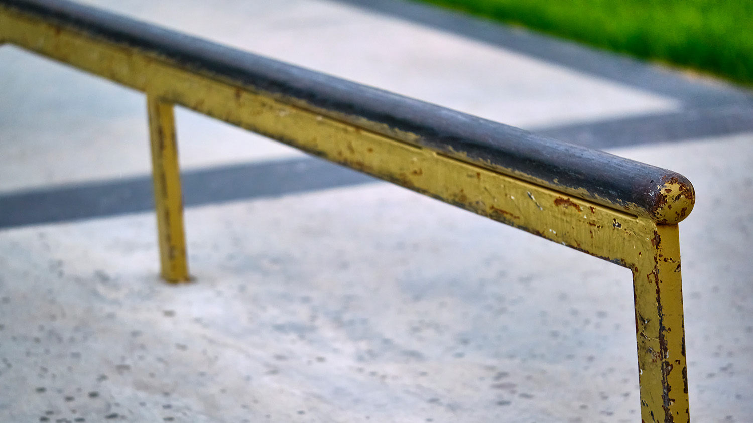 Worn metal skate park rail.